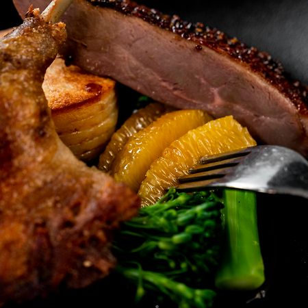 The Point Brisbane Hotel Dış mekan fotoğraf A duck confit with orange and vegetables